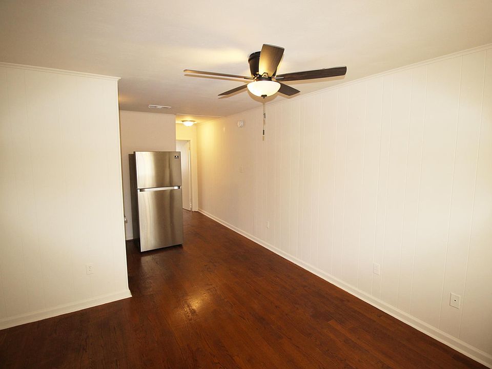 Living room with hardwood floors and a ceiling fan